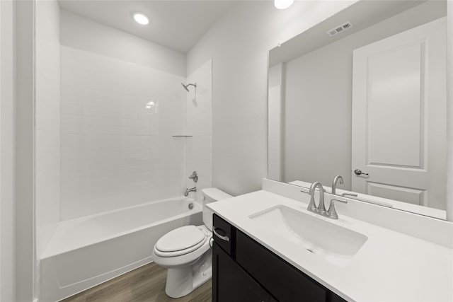 full bathroom with wood-type flooring, toilet, vanity, and shower / tub combination