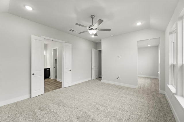 unfurnished bedroom with ceiling fan, lofted ceiling, and carpet floors