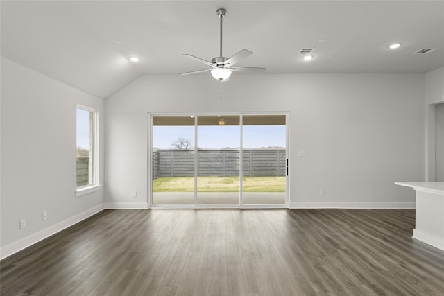 spare room featuring dark wood-type flooring, ceiling fan, and vaulted ceiling