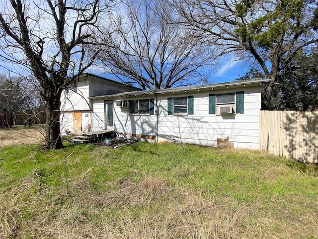 view of front of home featuring an AC wall unit