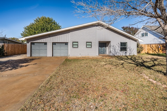 view of front of home with a garage and a front lawn