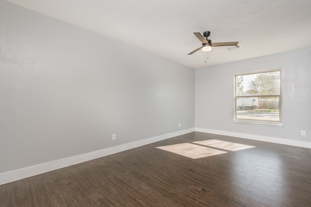 spare room with dark wood-type flooring and ceiling fan