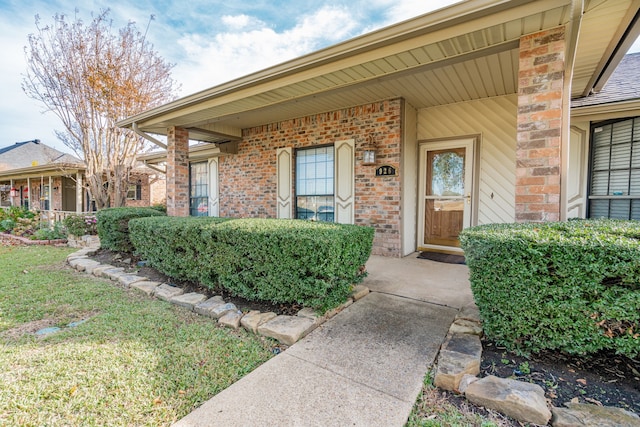 view of exterior entry with a porch