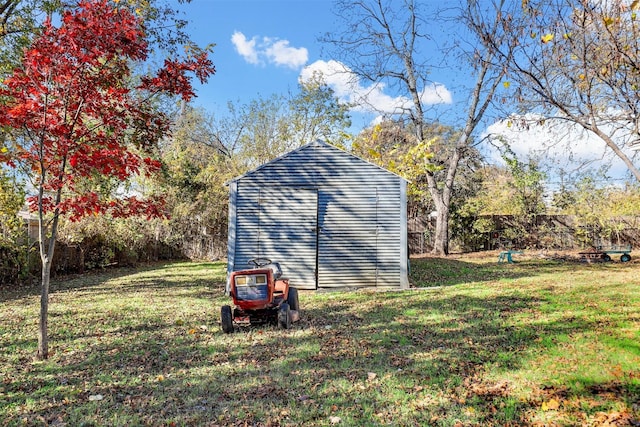 view of outbuilding featuring a lawn