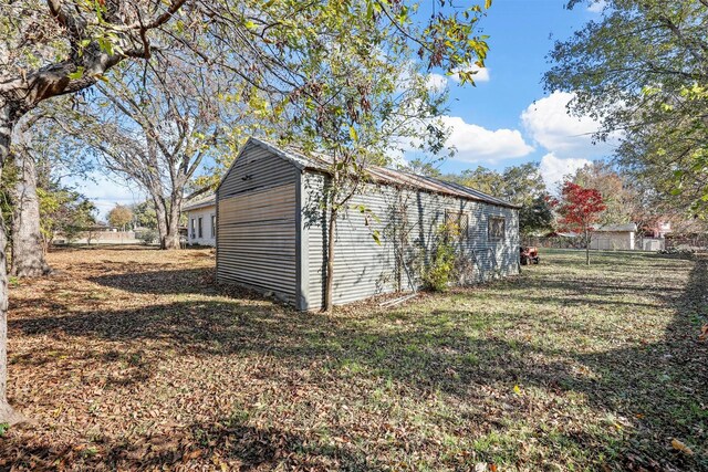 view of outdoor structure featuring a lawn