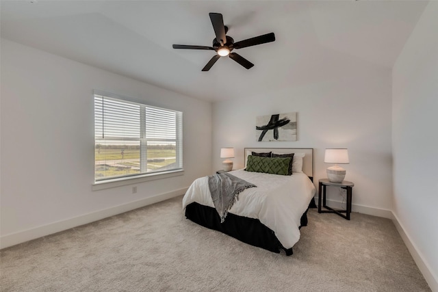 carpeted bedroom with ceiling fan and lofted ceiling