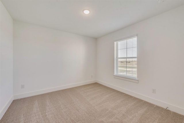 empty room featuring light colored carpet