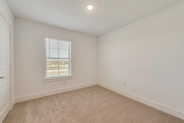 empty room featuring light carpet