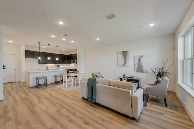 living room with light hardwood / wood-style flooring