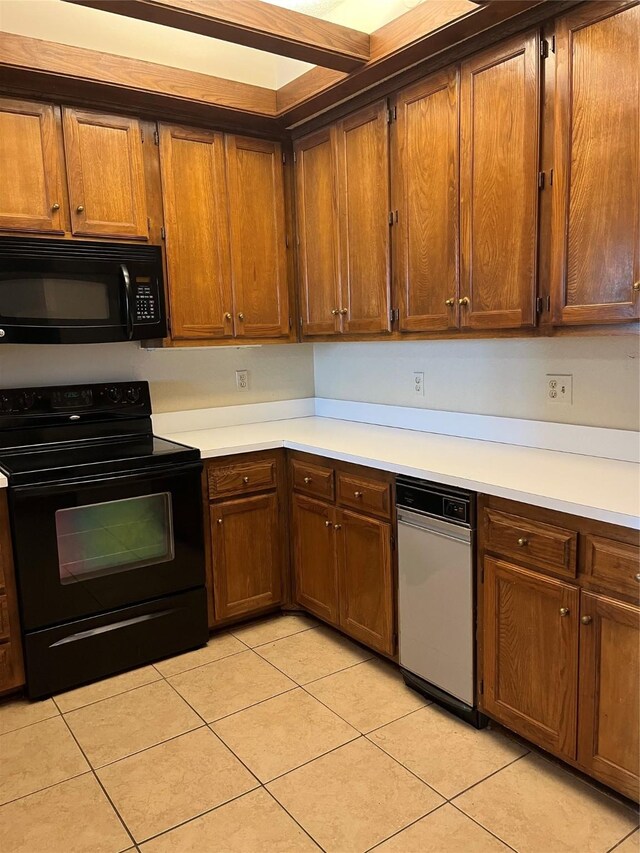 kitchen featuring light tile patterned flooring and black appliances