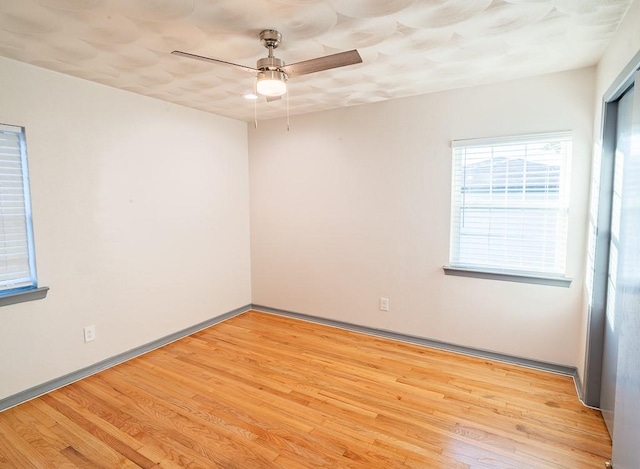 unfurnished room with ceiling fan and light hardwood / wood-style flooring