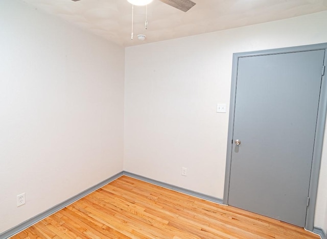 spare room featuring hardwood / wood-style flooring and ceiling fan