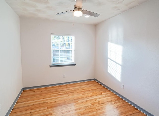 empty room with ceiling fan and light wood-type flooring