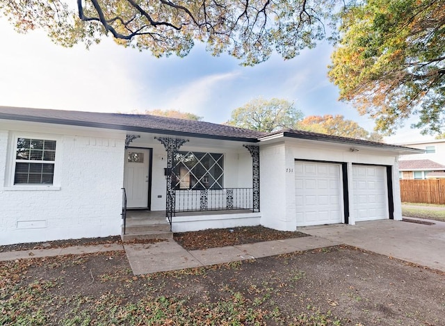 ranch-style home featuring a porch and a garage