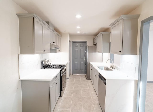 kitchen featuring sink, stainless steel appliances, backsplash, gray cabinets, and light tile patterned flooring