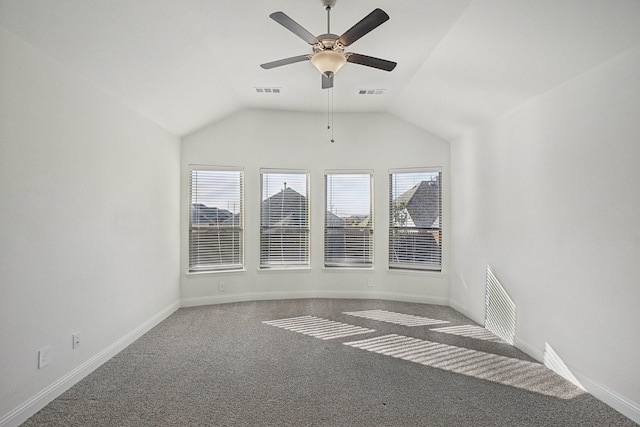 unfurnished room with ceiling fan, dark carpet, and vaulted ceiling