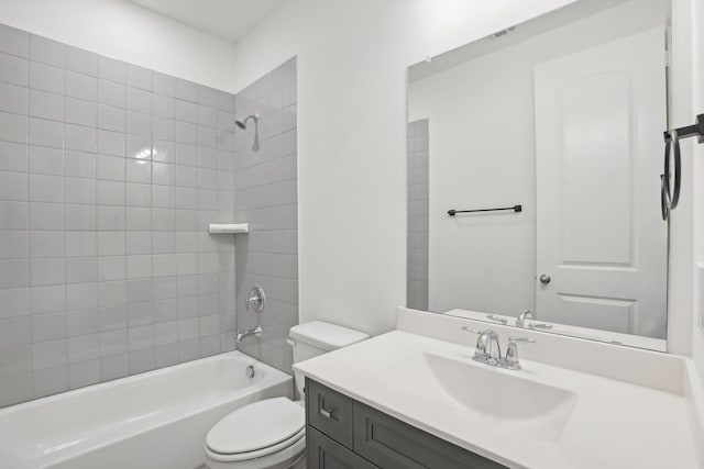 full bathroom with vanity, tiled shower / bath combo, and toilet