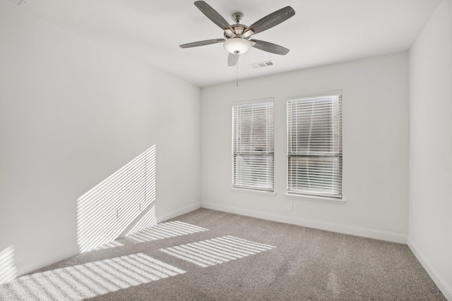 carpeted empty room featuring ceiling fan