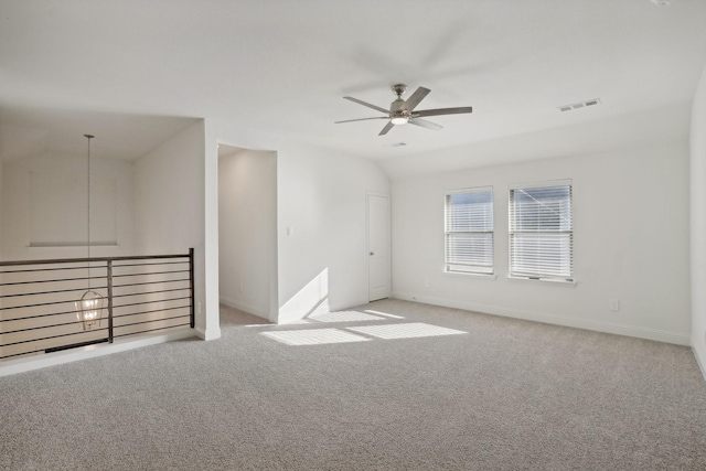 spare room featuring light carpet, ceiling fan, and lofted ceiling