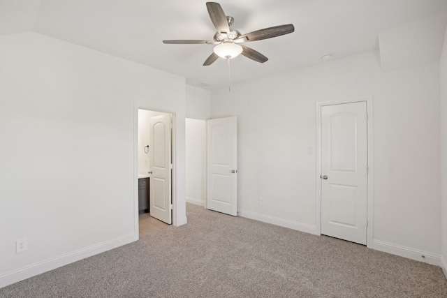 unfurnished bedroom featuring connected bathroom, ceiling fan, and light colored carpet