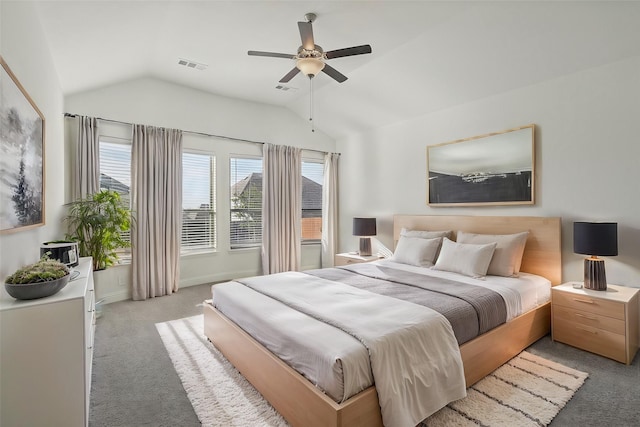 carpeted bedroom with ceiling fan and vaulted ceiling