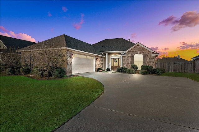 view of front of property with a lawn and a garage