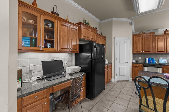 kitchen featuring tasteful backsplash, stainless steel dishwasher, black refrigerator, light tile patterned floors, and ornamental molding