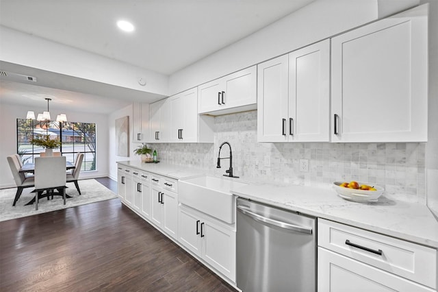 kitchen with white cabinetry, dark hardwood / wood-style flooring, stainless steel dishwasher, and sink