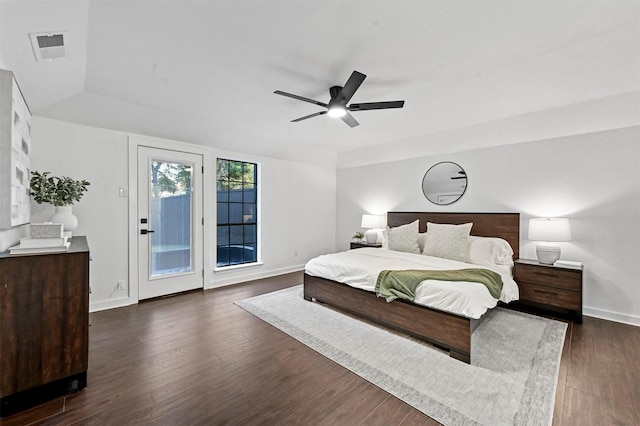 bedroom featuring ceiling fan, dark hardwood / wood-style floors, access to outside, and vaulted ceiling