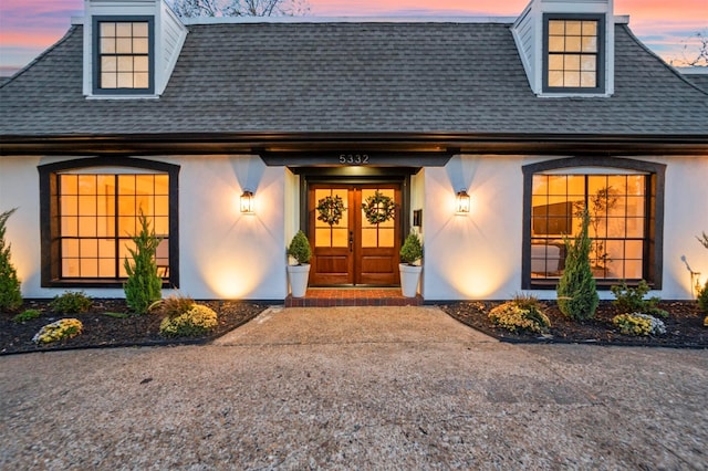 exterior entry at dusk with french doors