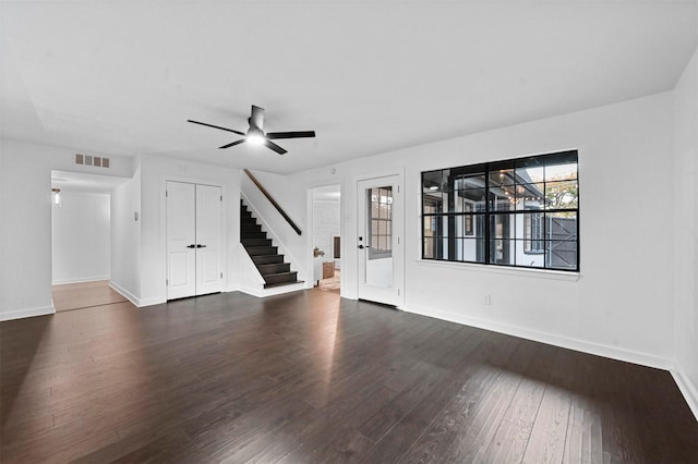 unfurnished living room with dark hardwood / wood-style floors and ceiling fan