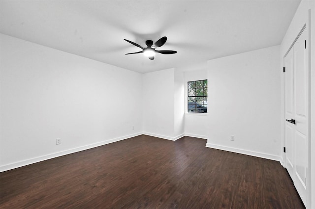 unfurnished room featuring dark wood-type flooring and ceiling fan