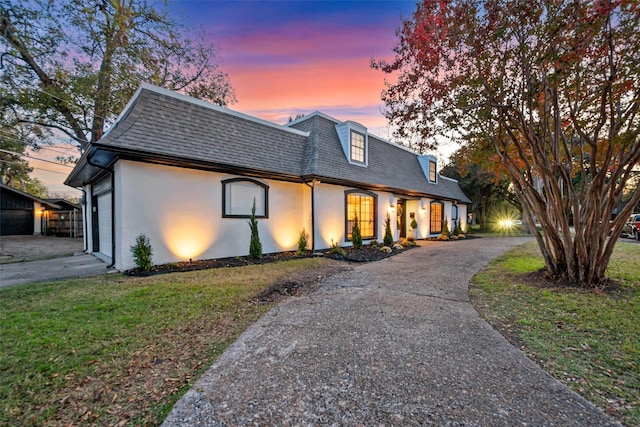 view of front of house featuring a garage and a yard