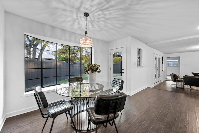 dining space featuring dark hardwood / wood-style flooring and a notable chandelier