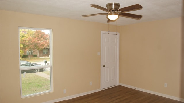 unfurnished room with ceiling fan, plenty of natural light, and dark hardwood / wood-style floors