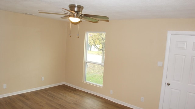 spare room with hardwood / wood-style floors, ceiling fan, and a wealth of natural light