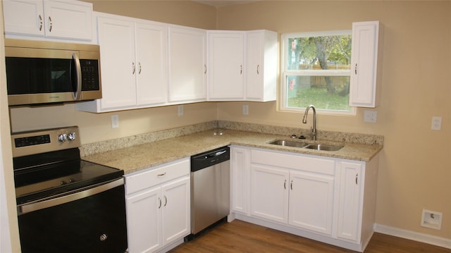 kitchen with white cabinets, dark hardwood / wood-style floors, sink, and stainless steel appliances