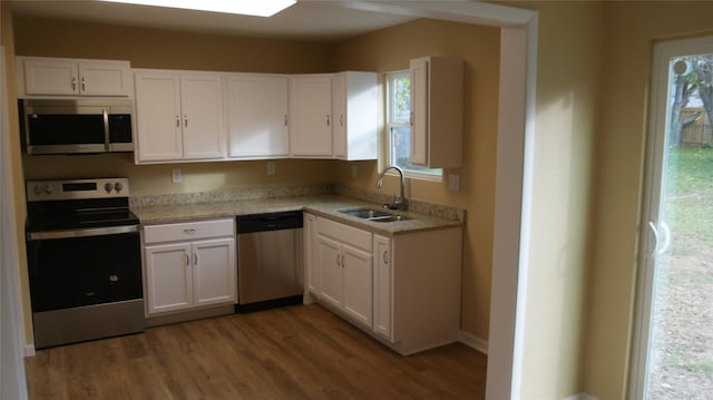 kitchen with white cabinets, a healthy amount of sunlight, sink, and appliances with stainless steel finishes