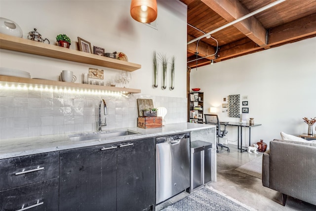 kitchen featuring light stone counters, dishwasher, tasteful backsplash, and sink