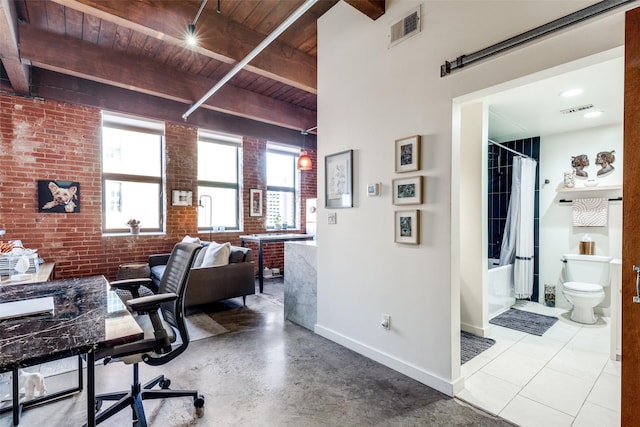 home office with beam ceiling, wood ceiling, and brick wall