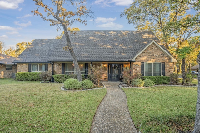 single story home with a front lawn