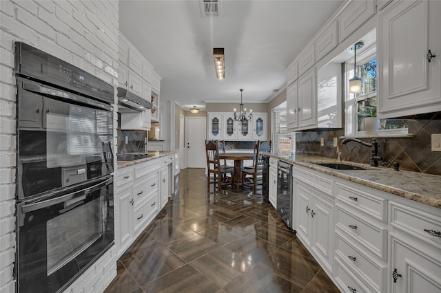 kitchen with light stone countertops, tasteful backsplash, decorative light fixtures, white cabinets, and black appliances