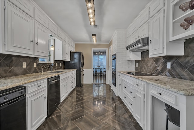 kitchen with black appliances, white cabinets, ornamental molding, and light stone counters