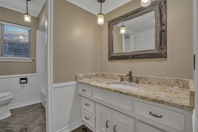 bathroom featuring vanity, tile patterned floors, toilet, ornamental molding, and a tub to relax in