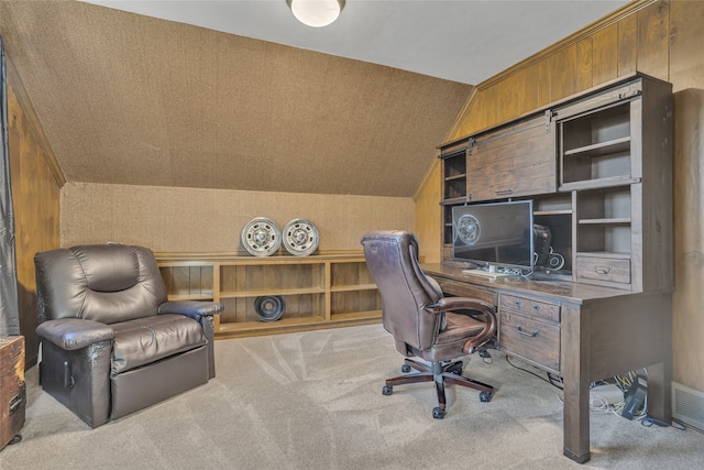 carpeted office featuring lofted ceiling and wooden walls