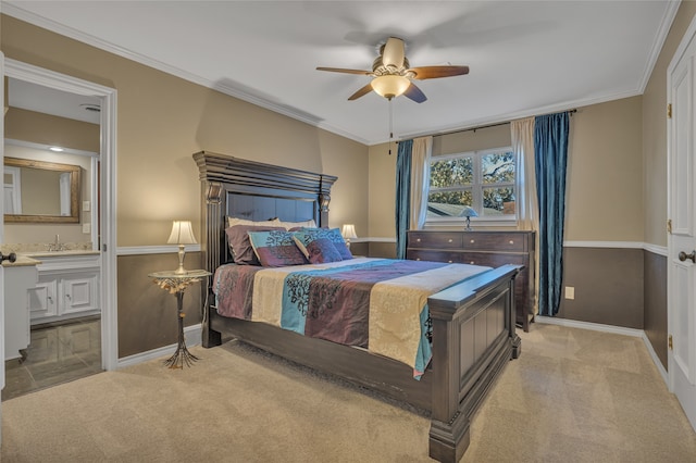 bedroom featuring ceiling fan, light colored carpet, ornamental molding, and ensuite bathroom