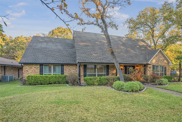 view of front of house featuring central AC and a front lawn