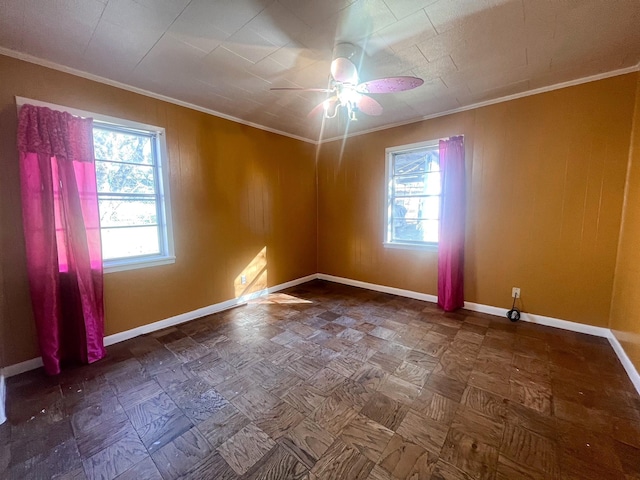 spare room featuring a wealth of natural light, ornamental molding, and ceiling fan