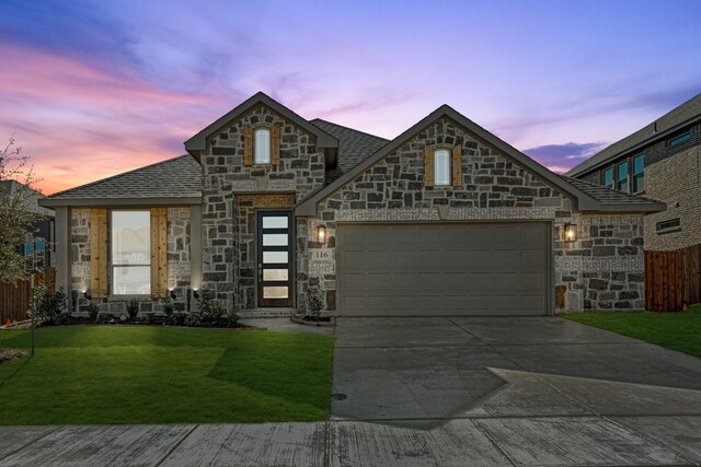 french country home with a front yard and a garage