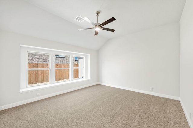 carpeted empty room featuring vaulted ceiling and ceiling fan